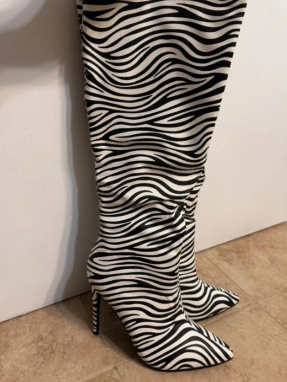 Knee high zebra print stiletto boots